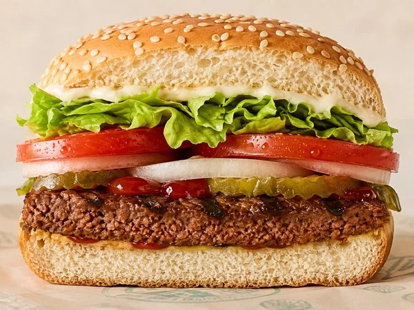 Close-up of the Burger King Plant-Based WHOPPER showing the soy protein patty, lettuce, tomato and vegan mayo